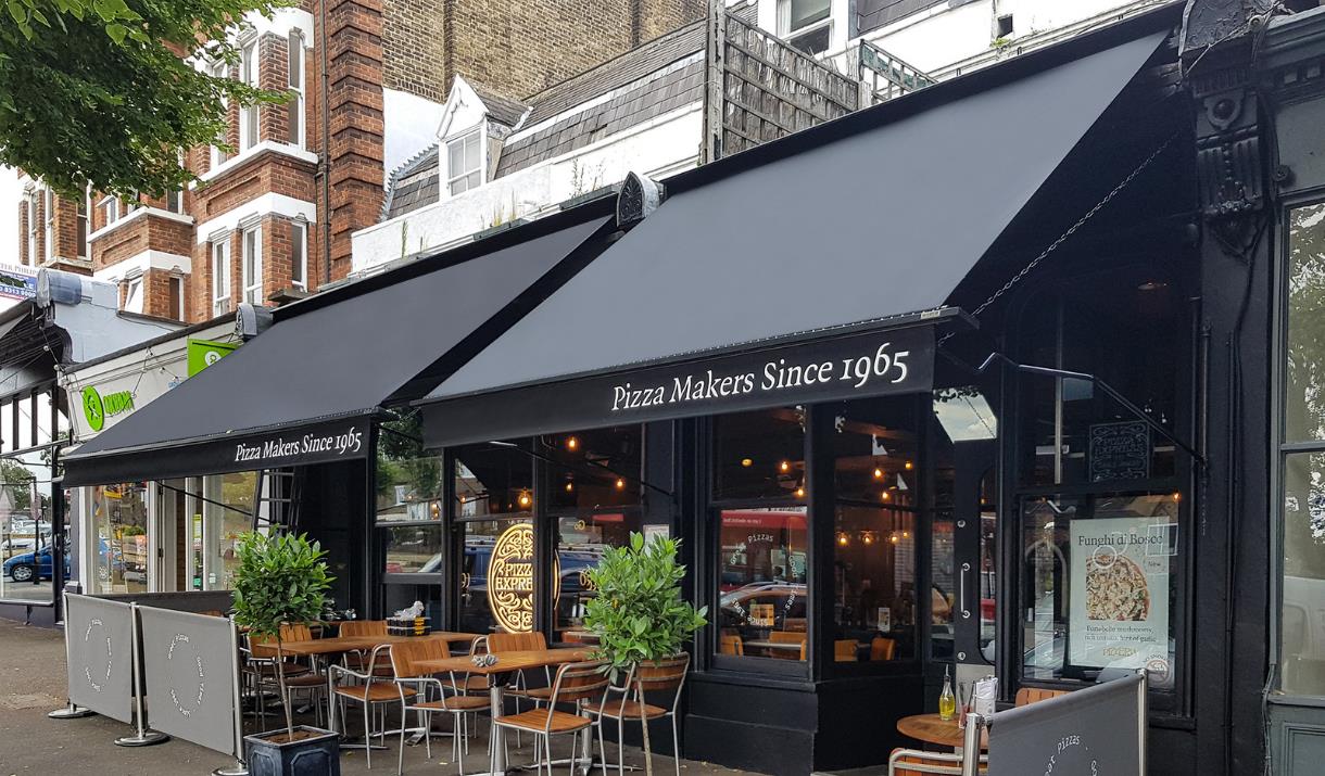 Pizza Express Blackheath, showing a blacked out restaurant with outdoor and indoor seating.