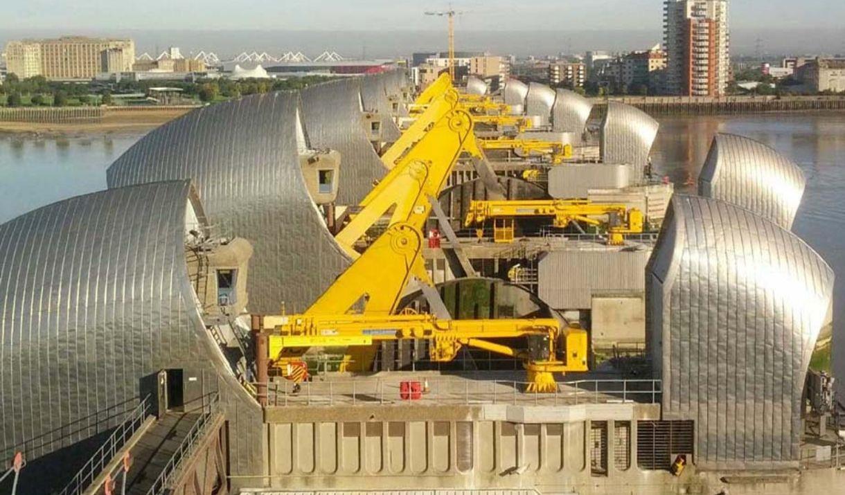 Looking north over the Thames Barrier from above across all the gates on a sunny day