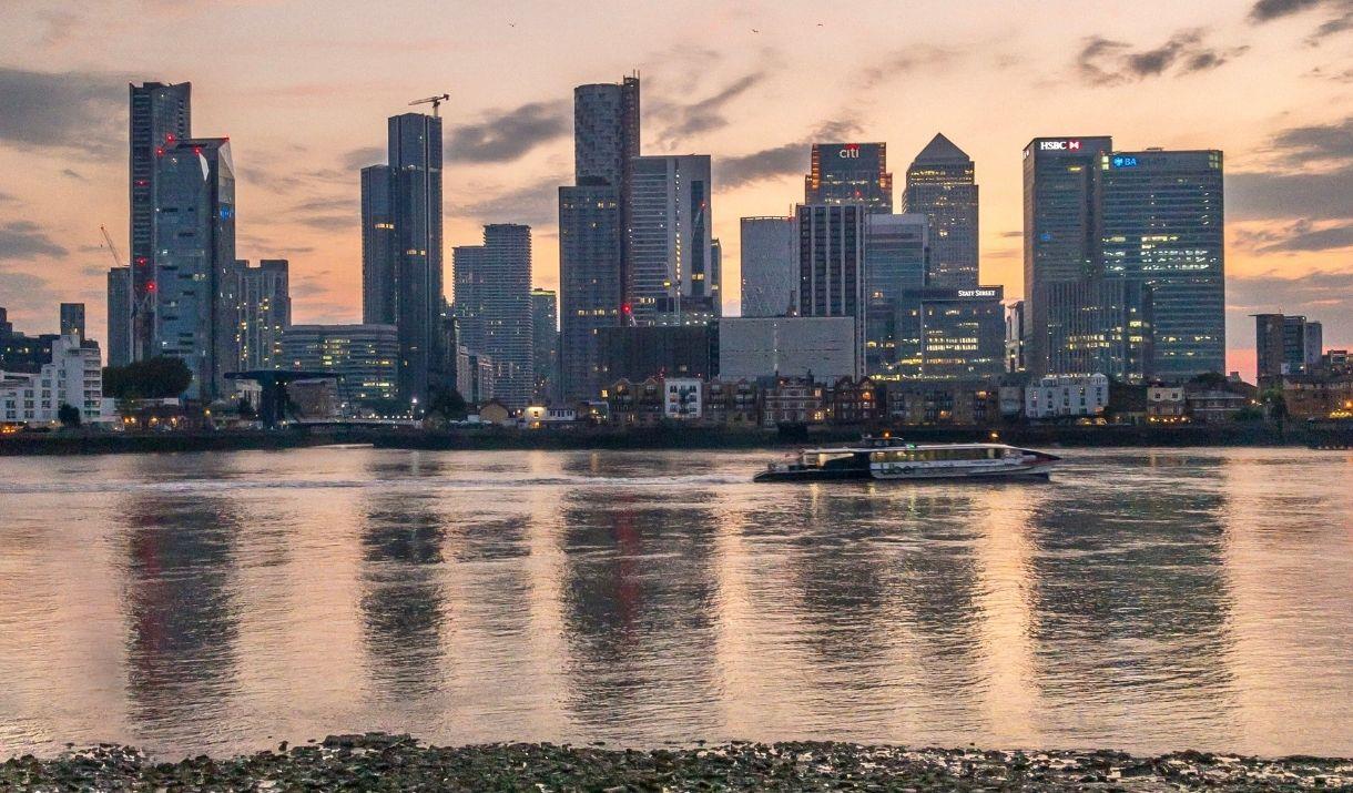 Speeding down the Thames past Canary Wharf on Uber Boat by Thames Clippers.