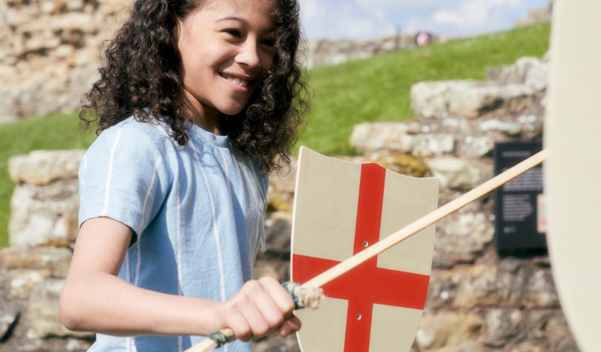 Child playing with sword and shield