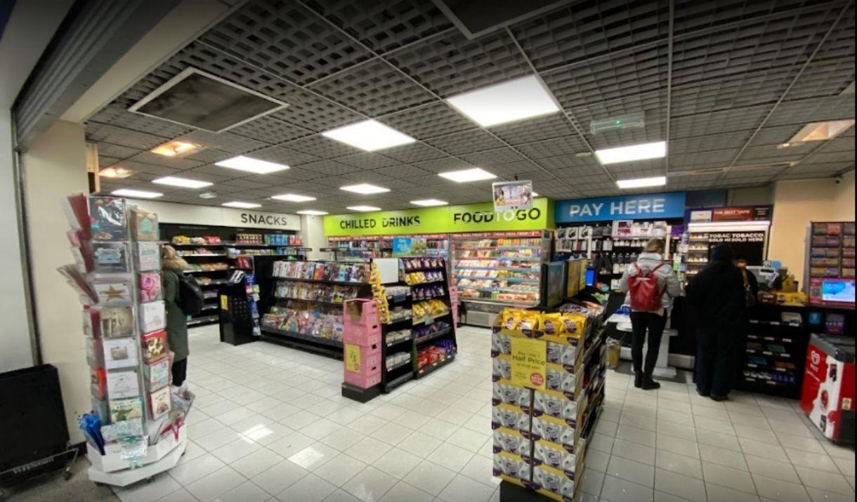 Inside WHSmiths in Greenwich, showing a small newsagents filled with snacks, drinks, cards, magazines, books and more.