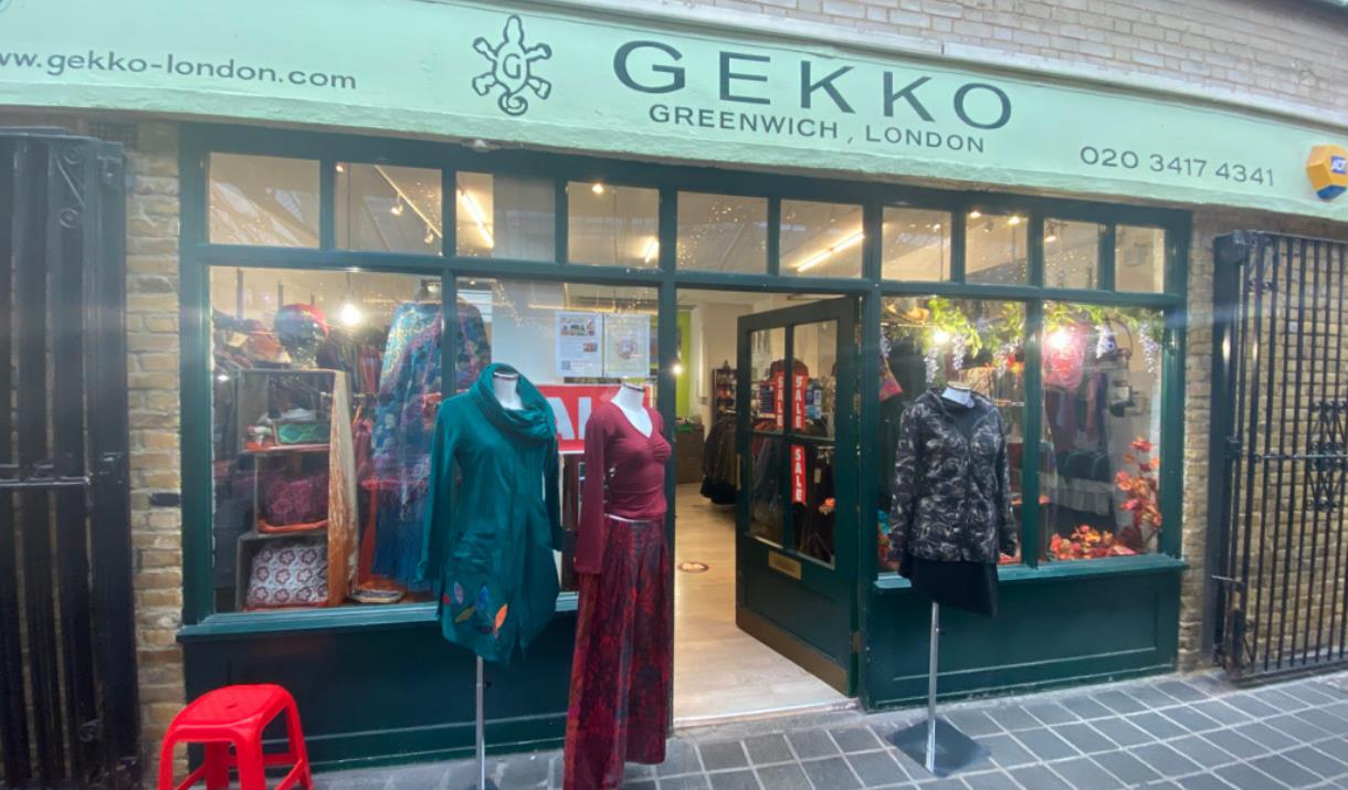 Outside GEKKO in Greenwich, showing a green shop front with a range of clothing on show.