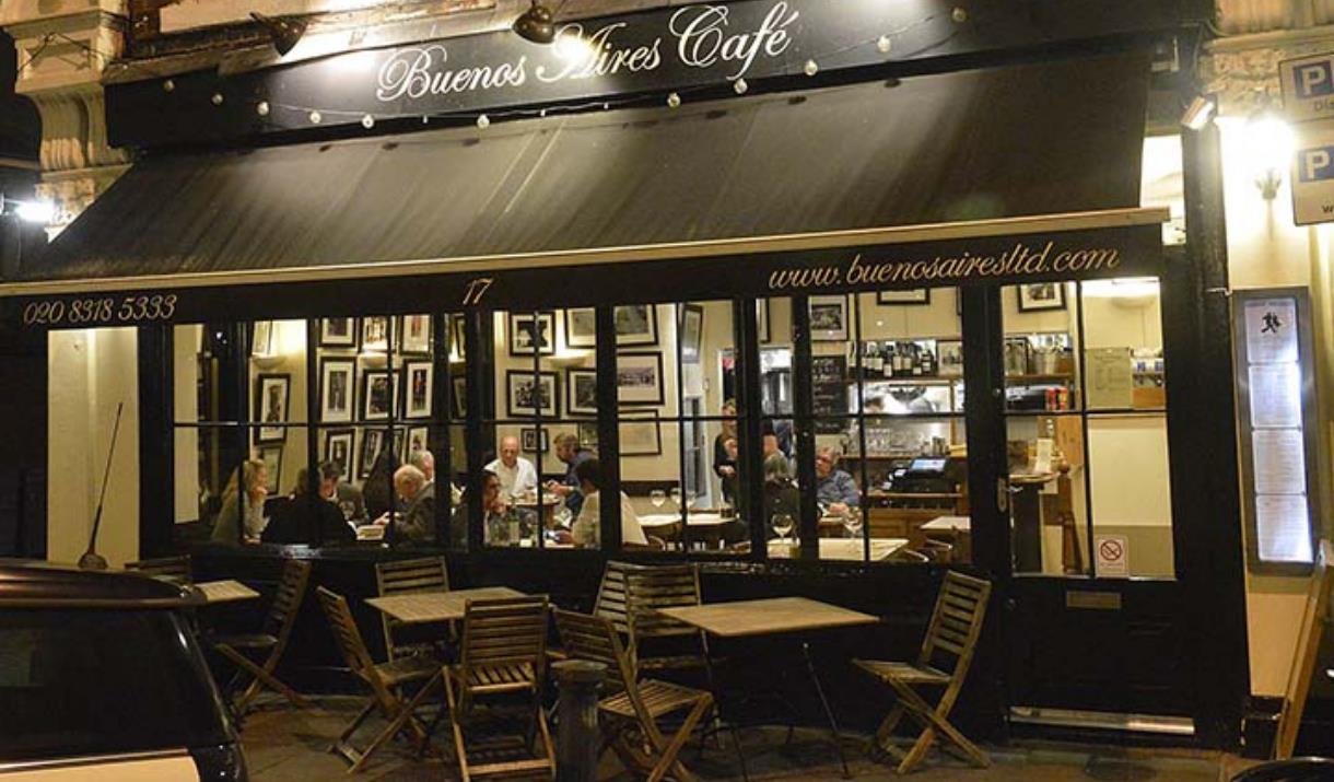 Buenos Aires Cafe, Blackheath entrance is lit up well with brown frame and big windows looking outside.  Outside seating available as well.