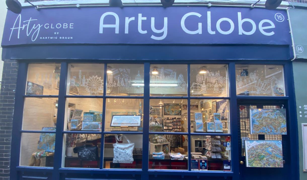 Outside Arty Globe in Greenwich. A blue and white shop front with a stunning artwork display inside the window.