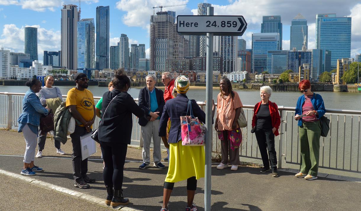 A group of people join a BSL Guided Tour beside Thomson and Craighead's 'Here' (2013) artwork