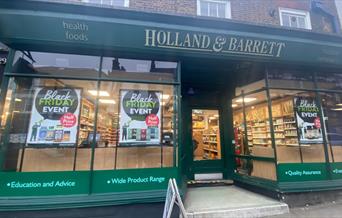 Outside Holland & Barrett in Blackheath. A green shop filled with a huge selection of health products.
