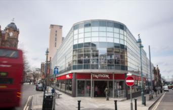 Outside TK Maxx in Woolwich, showing a big and
modern glass building.