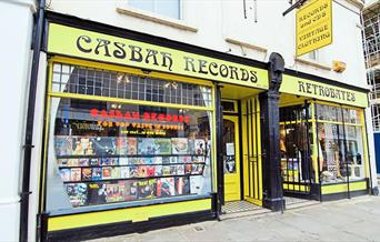 Outside Casbah Records in Greenwich, showing a yellow and black shop with a huge selection of records.