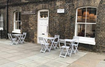 Jade Boulangerie is based in a brick finished building within the Royal Arsenal with a white entry door.  There is outside seating available as well a