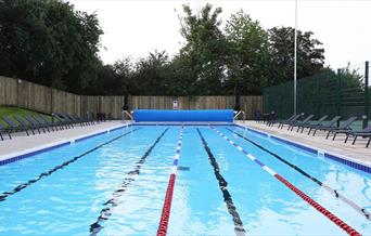 An outdoor swimming pool at David Lloyd Kidbrooke.