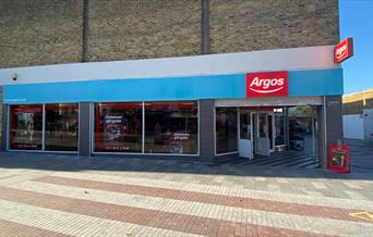 Inside of Argos Eltham, showing a large room with screens for products and a collection point.