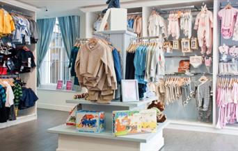 Inside JoJo Maman Bebe, a bright and stunning shop filled with a range of baby and children's clothes.