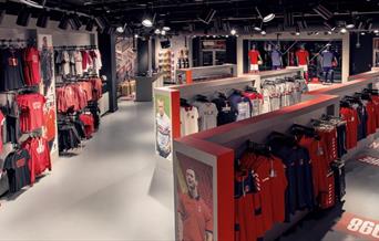 Inside the Charlton FC club shop, showing a big lit up room filled with CAFC Merchandise.