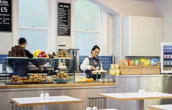 Astronomy Café, showing a counter with a range of delicious foods and drinks. As well as tables for you to sit and relax.