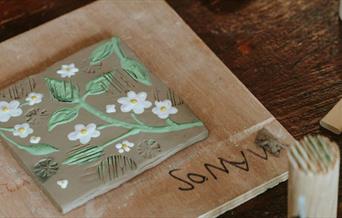 Ceramics workshop led by award-winning artist, Manos, focused on creating and designing your own ceramic tile