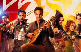 Film poster for Dungeons & Dragons showing six characters dressed in roleplaying costume and holding weapons or musical instruments