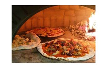 Serving freshly baked wood fired pizza at your doorstep