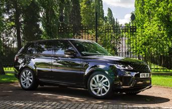 A black Range Rover outside an ornate black gate available to rent in Greenwich, London.