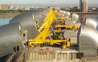 Looking north over the Thames Barrier from above across all the gates on a sunny day