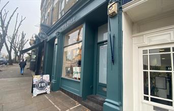 Farrow and Ball in Blackheath. Showing a green shopfront with an elegant inside.