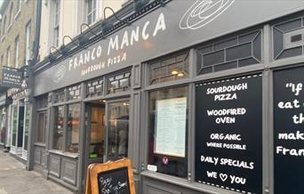 Outside Franco Manca in Greenwich, showing a classy restaurant with lots to offer.