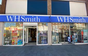 Outside WHSmith in Eltham, showing their famous blue and white logo attached to a welcoming shop.