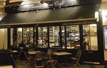 Buenos Aires Cafe, Blackheath entrance is lit up well with brown frame and big windows looking outside.  Outside seating available as well.