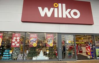 Outside Wilko in Charlton. A large shop with glass doors and a red sign outside.