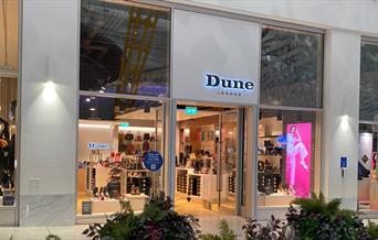 Dune at the O2. A stunning square shaped shop with a black and white design. Inside the windows are an amazing collection of footwear.
