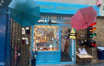 Outside London Orgone. A stunning shop, with a light blue and gold design. Also having a unique umbrella display outside.