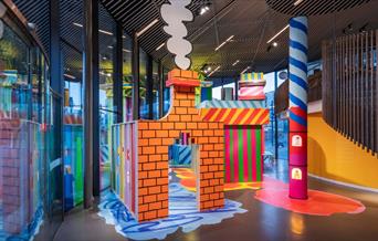 NOW Gallery's 2024 Design Commission sees the gallery space transformed into a vibrant, colourful and interactive installation that tells the story of
