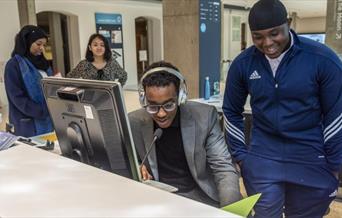 A diverse set of four young people at work.