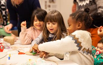 Three children making rope creations