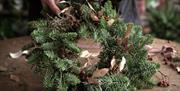 Celebrate creativity and craftsmanship as you learn to design your own natural wreath using a blend of fresh and preserved foliage, pinecones, dried f