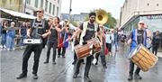 Brass band marching through Woolwich town centre