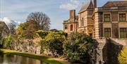 Eltham Palace surrounded by the beautiful gardens and moat.