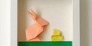 A relaxed, multi-generational session where participants create individual pieces using simple origami, collage and card-making within a shared theme.