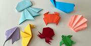 A relaxed, multi-generational session where participants create individual pieces using simple origami, collage and card-making within a shared theme.