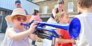An annual day-long street brass festival and carnival of horns