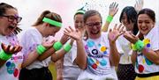 A group of adults taking part in the Rainbow Run