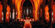 An intimate candlelit setting at St Alfege Church, Greenwich, featuring a captivating live string trio performance 🎻