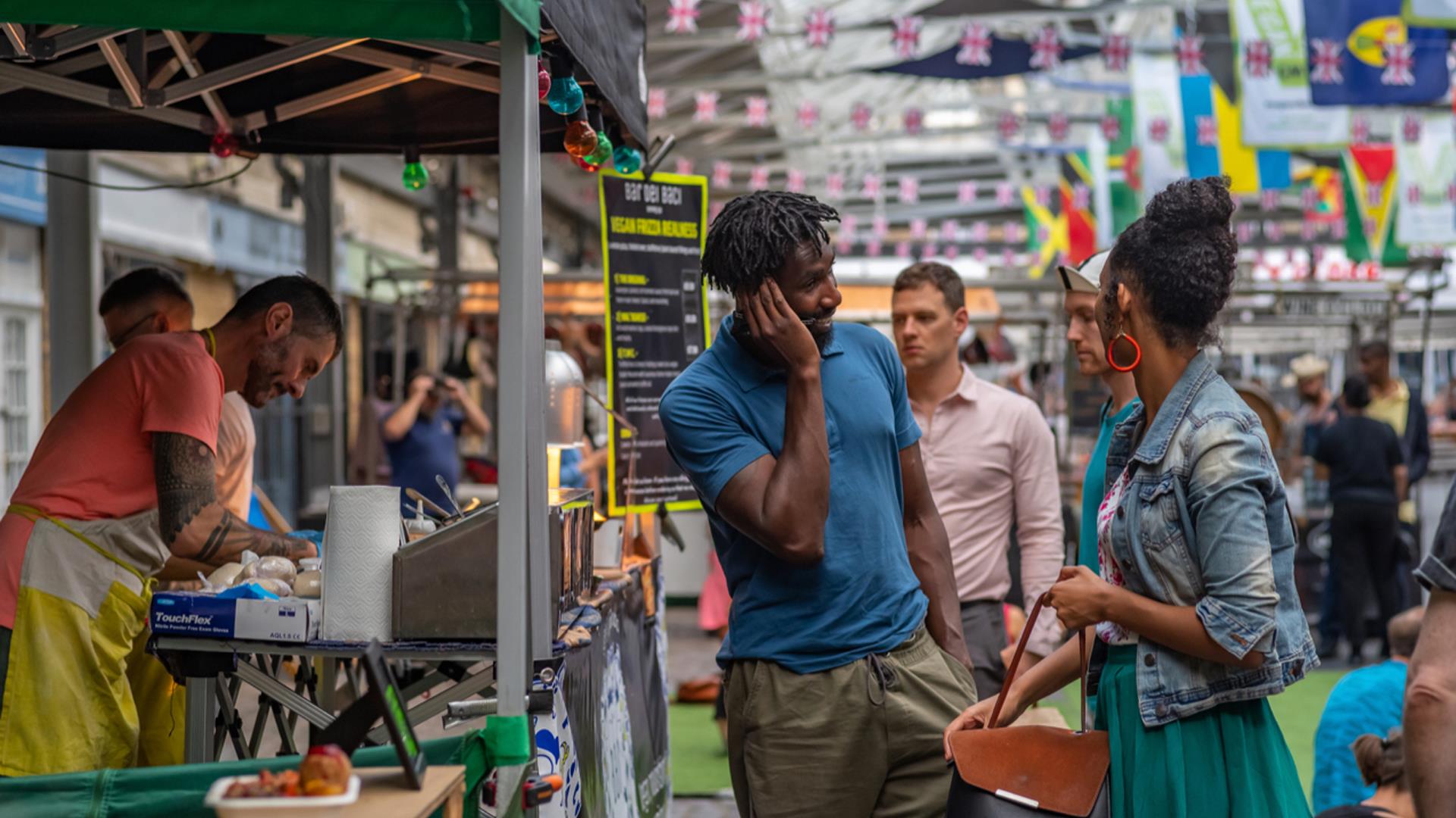 A couple talking at a market stall in Greenwich Market.