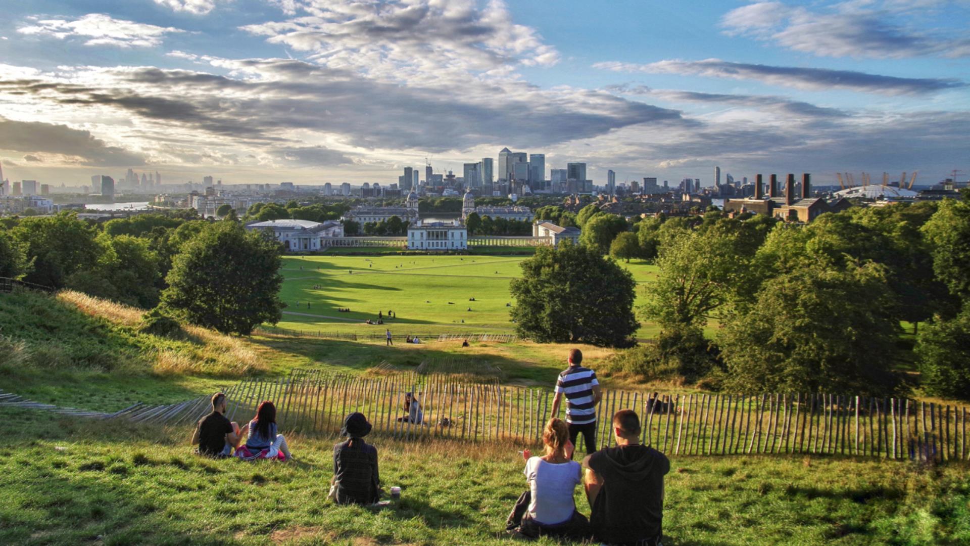The view of Greenwich from the top of the hill in Greenwich Park over The Queen's House, National Maritime Museum and Canary Wharf.