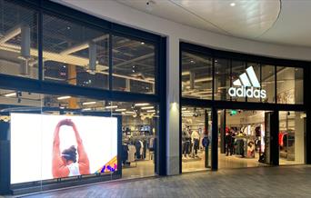 Outside Adidas at The O2. Showing a large and stylish building with a huge selection of items inside.