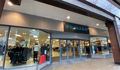 A photo taken outside of Primark, showing a fashion paradise filled with a huge variety of items.