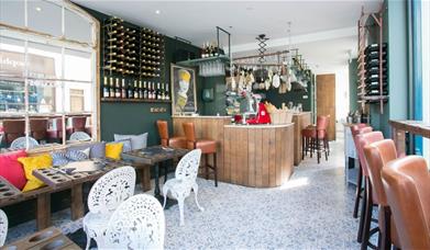 Interior image of Champagne + Fromage Greenwich restaurant with bar and dining area.