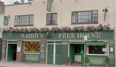 Exterior image of Hardy's Freehouse with green and beige entrance.
