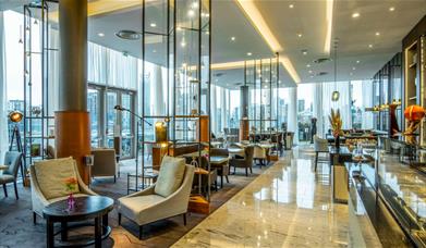The bright and airy Meridian Lounge at InterContinental London - The O2 has stunning views through the floor to ceiling windows of the river Thames an