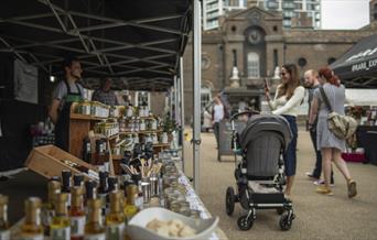 People stop to look at the range of goodies on offer at Royal Arsenal Farmers Market in Woolwich, Greenwich
