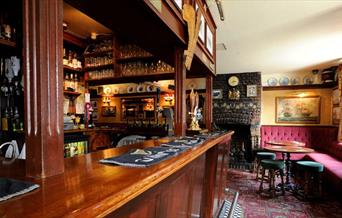 The beautiful old wooden bar at The Plume of Feathers in Greenwich.